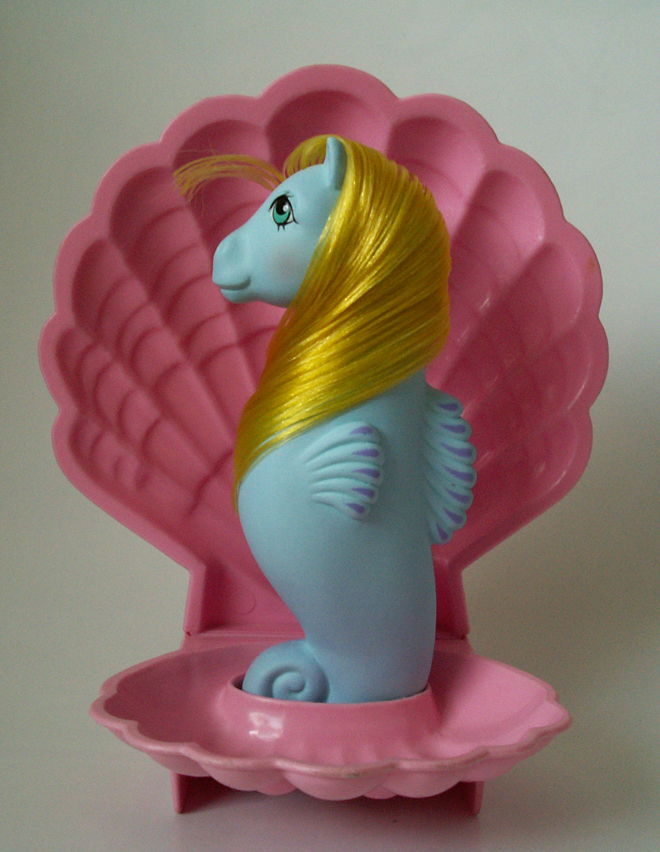 Surf Dancer is a blue adult sea pony with blue eyes and yellow hair. Surf Dancer is a blue adult sea pony with blue eyes and yellow hair.
